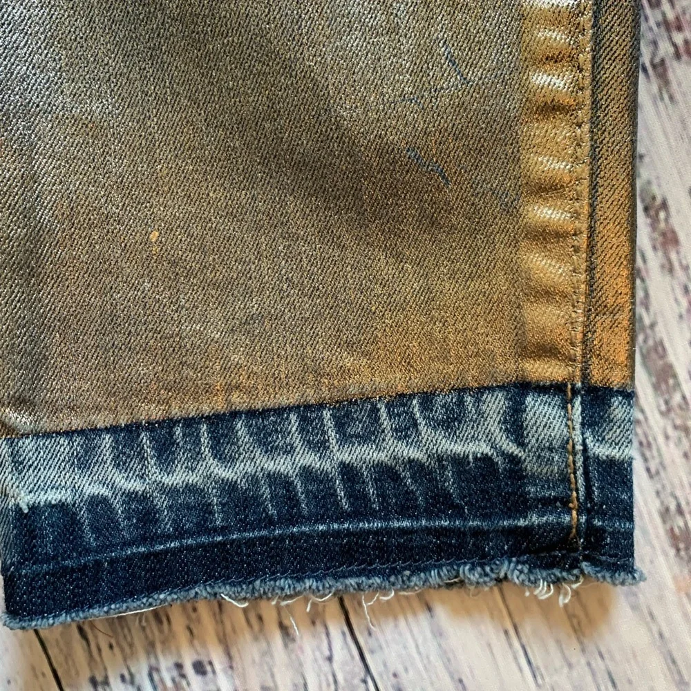Level 99 jeans. Gold/silver design on bottom. Mid rise. Size 27.